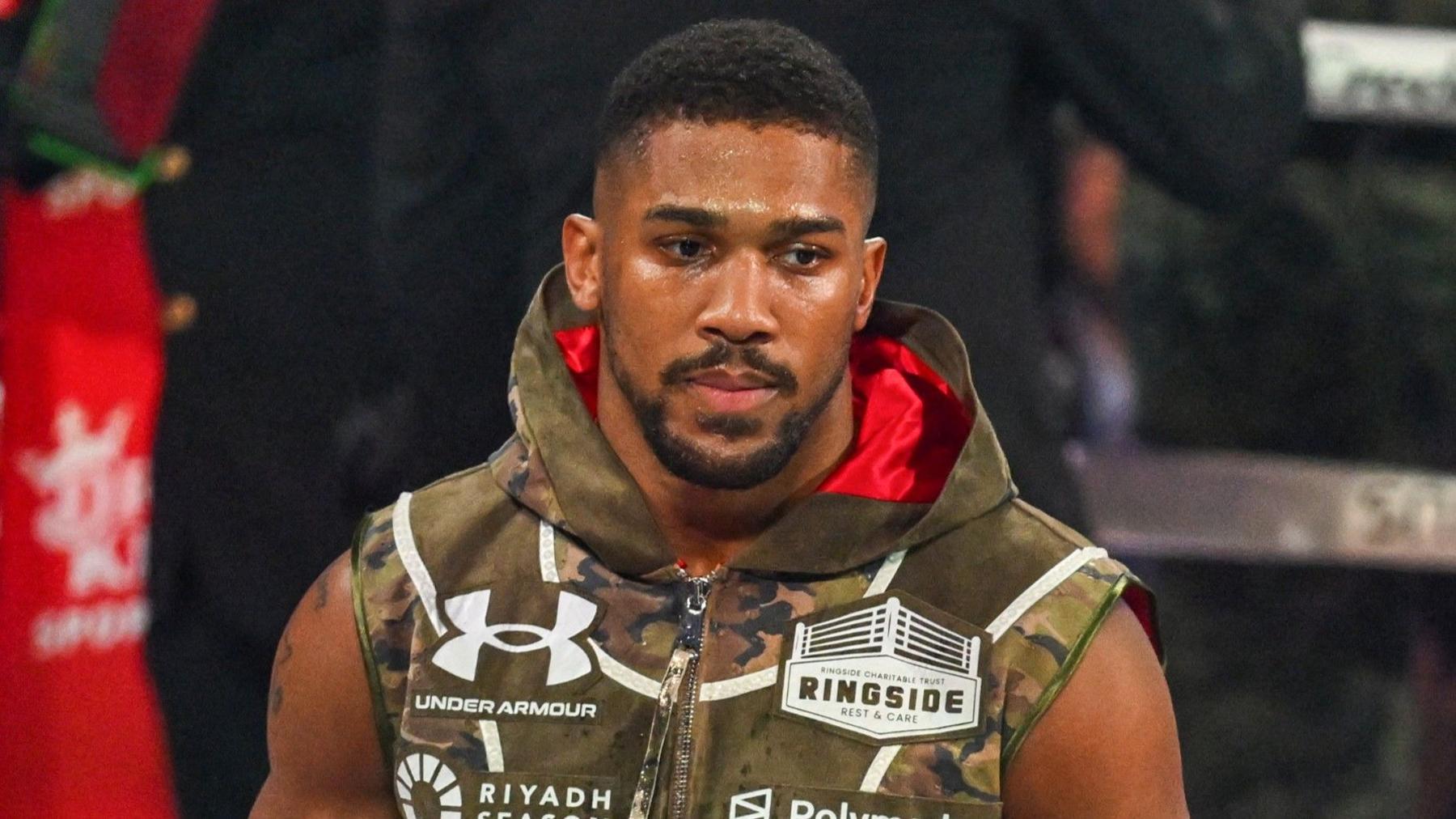 Anthony Joshua makes his way back to the gym after the car accident in Nigeria.