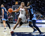 Sarah Strong guides the elite UConn team to their 34th consecutive victory, defeating Villanova 99-50.